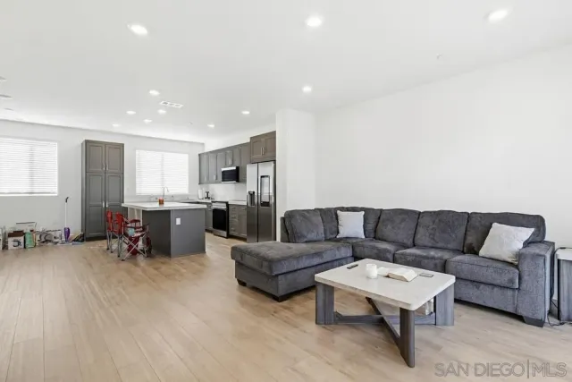 a living room with furniture and kitchen view