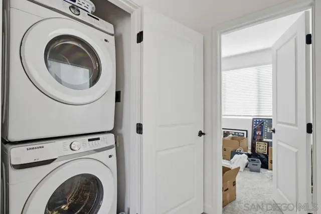 a view of a hallway with washer and dryer