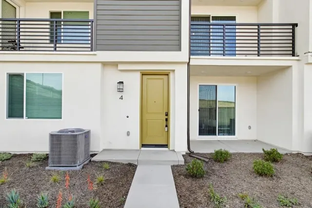 a view of a brick house with potted plants