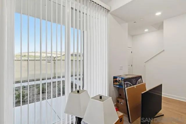 a view of a workspace with furniture and a window