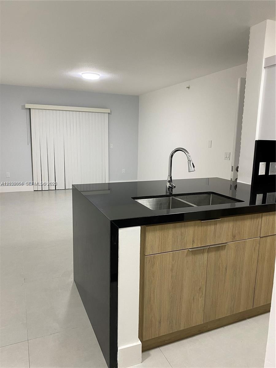 15480 Southwest 284th Street, Unit 2203 Homestead, FL 33033 - Photo 5 of 13 a kitchen with a sink and cabinets