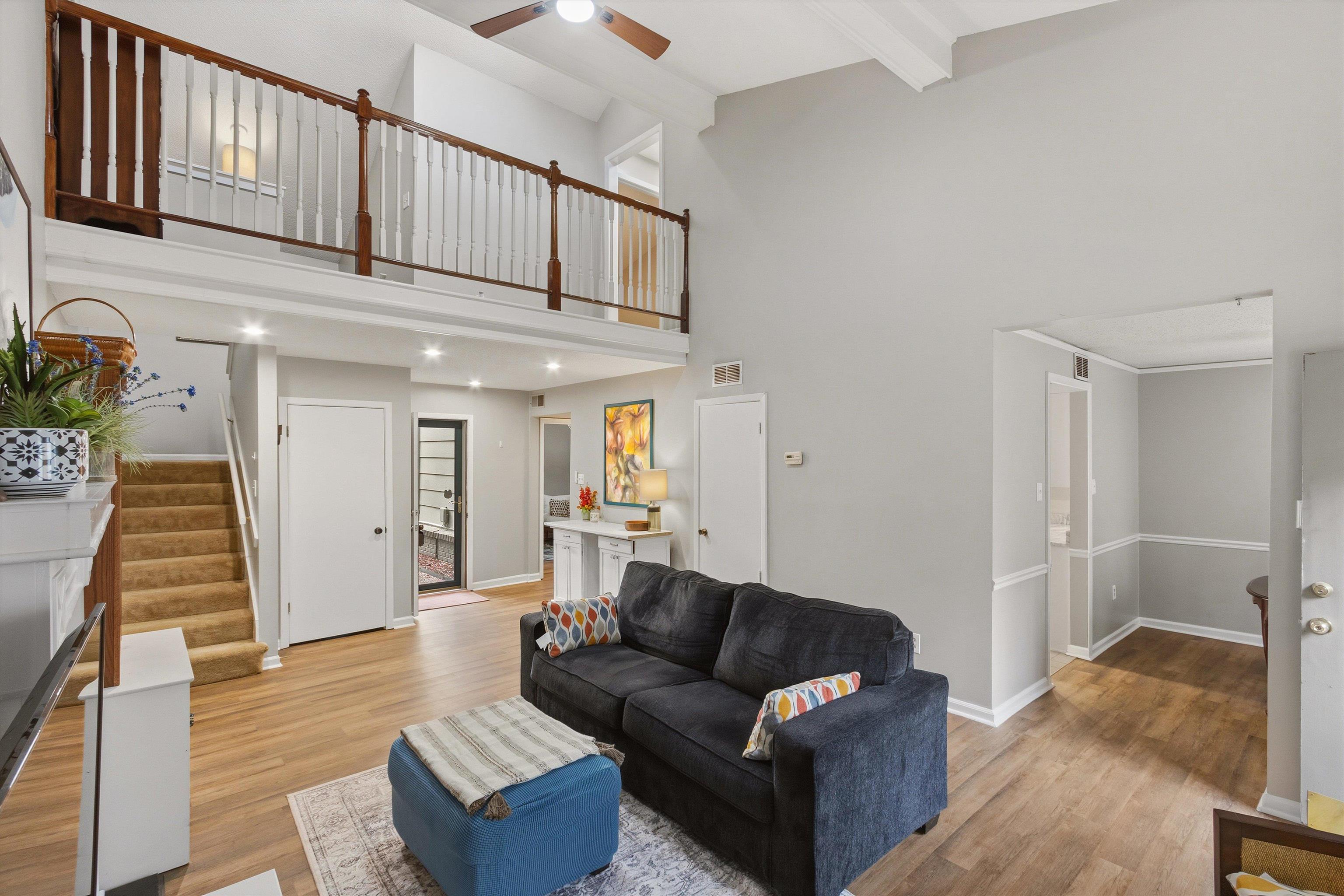 1906 Allenby Road, Unit 16 Germantown, TN 38139 - Photo 9 of 31 Vaulted ceiling with exposed beams, wood-finish flooring, recessed lighting, carpeted staircase, and wood railing on the upper level