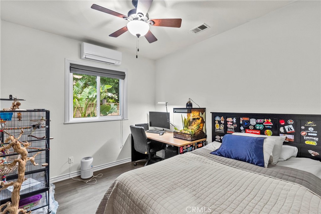 29859 Cashmere Place Castaic, CA 91384 - Photo 28 of 48 a bedroom with a bed and a chandelier