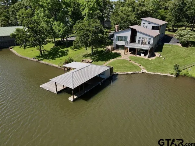 an aerial view of a house with swimming pool garden and mountain view