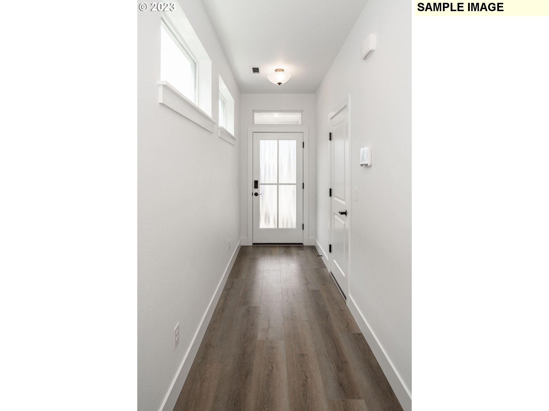 17535 Northwest 7th Avenue Ridgefield, WA 98642 - Photo 3 of 32 a view of a hallway with wooden floor