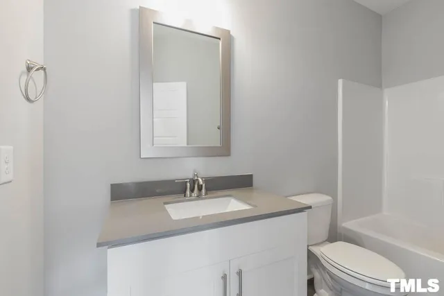 a bathroom with a sink toilet and a mirror