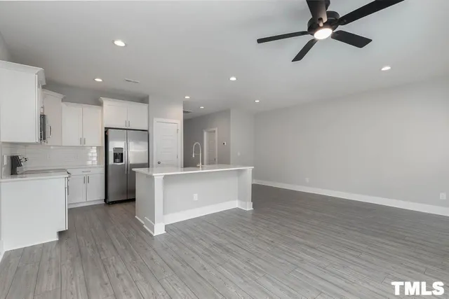 a view of kitchen with refrigerator microwave and stove