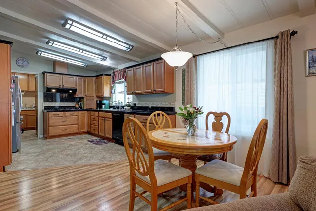 a kitchen with granite countertop a refrigerator and cabinets