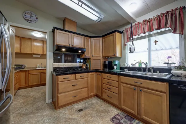 a large living room with stainless steel appliances kitchen island granite countertop a living room