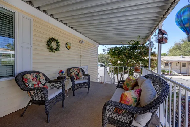 a backyard of a house with fire pit and outdoor seating