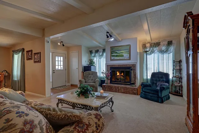 a view of a dining room with furniture and chandelier