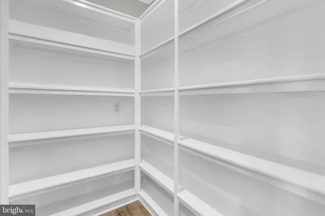 a view of empty room with a kitchen