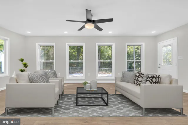 a view of an empty room with closet and a window