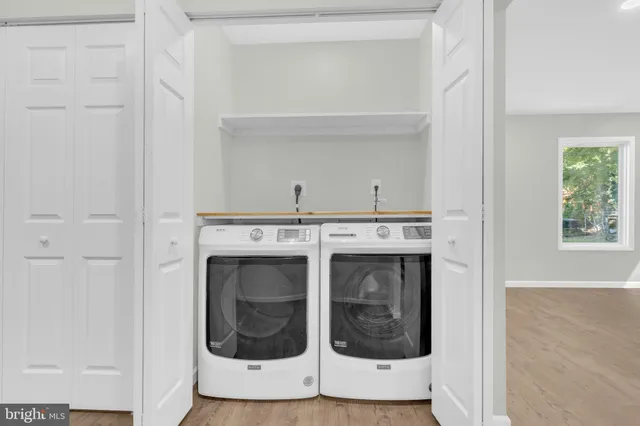 a spacious bedroom with a bed and a painting on the wall