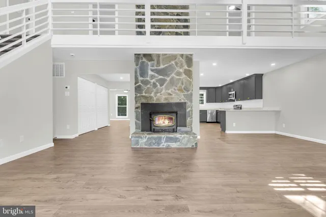 a view of a livingroom with a ceiling fan and a kitchen
