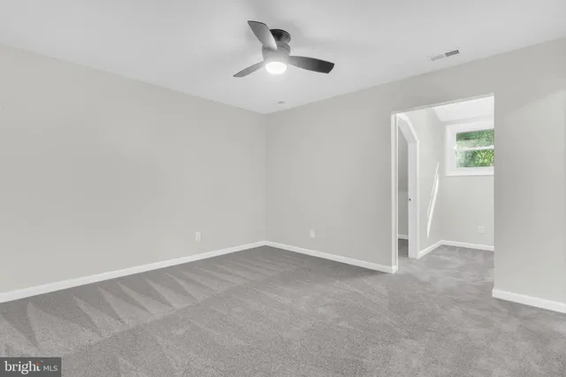 a bathroom with a granite countertop shower and a sink