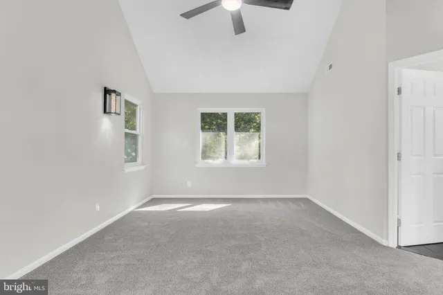 an aerial view of a house with a yard basket ball court and outdoor seating