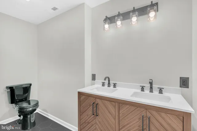 an aerial view of residential house with outdoor space and trees all around