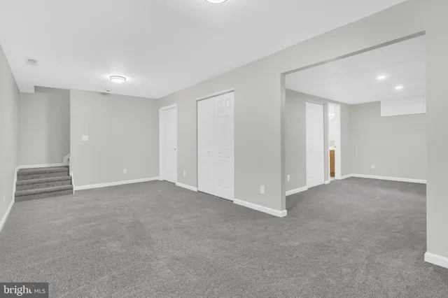an aerial view of a house with a yard and large trees