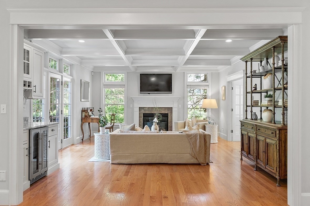 25 Shade Street Lexington, MA 02421 - Photo 17 of 42 a living room with furniture a flat screen tv and a fireplace