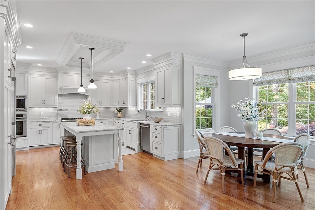 25 Shade Street Lexington, MA 02421 - Photo 18 of 42 a kitchen with a table chairs sink and cabinets