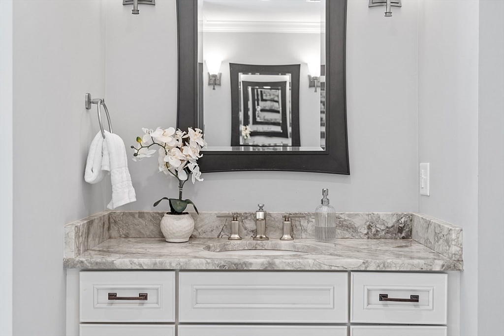25 Shade Street Lexington, MA 02421 - Photo 29 of 42 a bathroom with sink and mirror