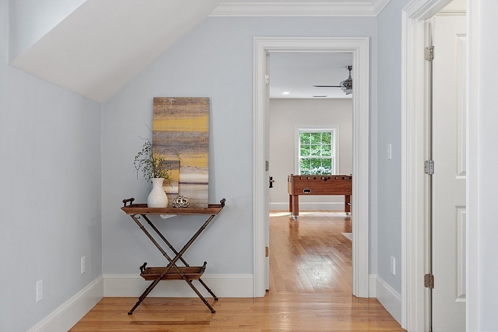 25 Shade Street Lexington, MA 02421 - Photo 32 of 42 a view of a hallway with wooden floor and a workspace