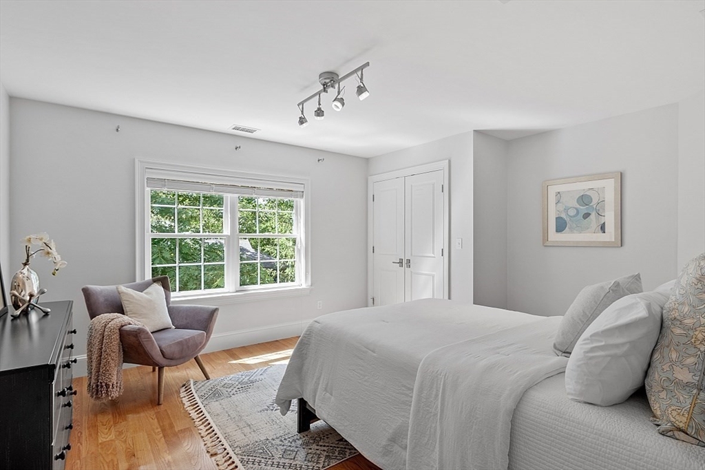 25 Shade Street Lexington, MA 02421 - Photo 33 of 42 a bedroom with a bed and glass window