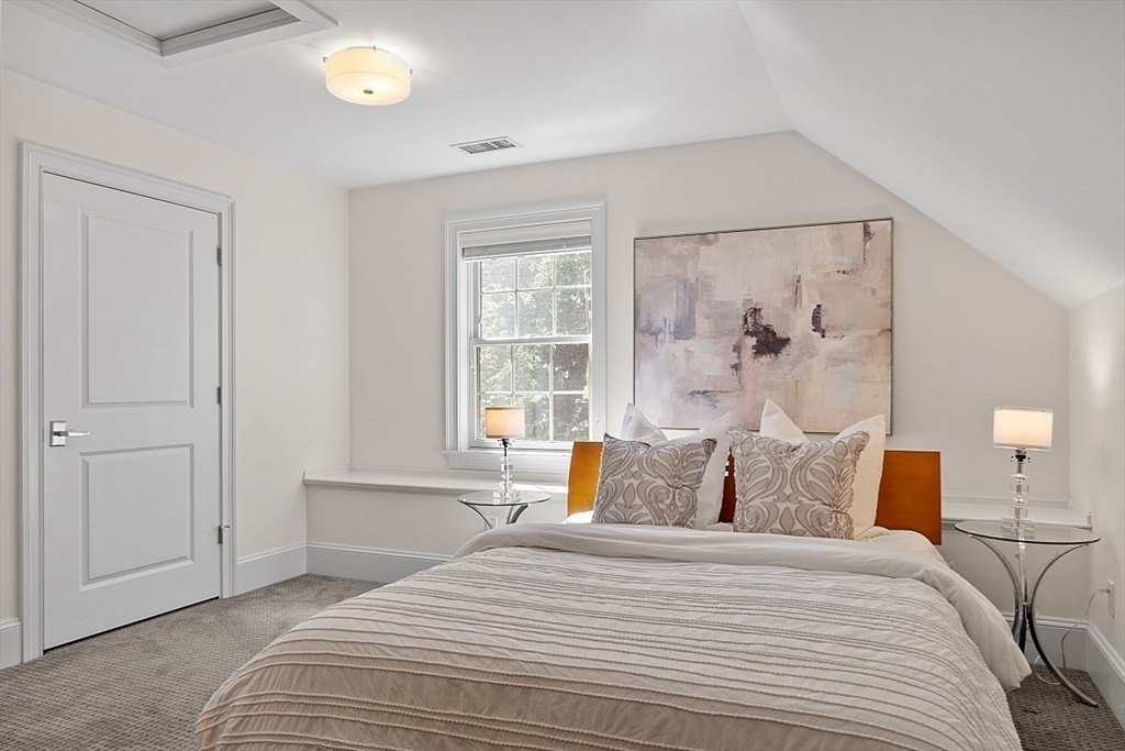 25 Shade Street Lexington, MA 02421 - Photo 36 of 42 a bedroom with a bed and window