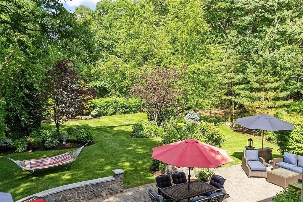 25 Shade Street Lexington, MA 02421 - Photo 39 of 42 a view of a with table and chairs under an umbrella