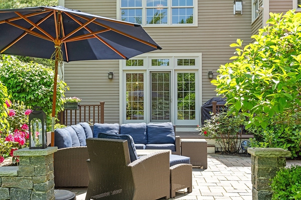 25 Shade Street Lexington, MA 02421 - Photo 41 of 42 a patio with table and chairs and potted plants