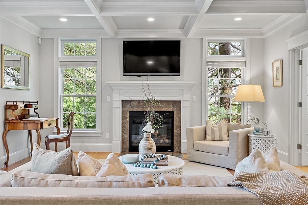 25 Shade Street Lexington, MA 02421 - Photo 8 of 42 a living room with furniture a fireplace and a flat screen tv