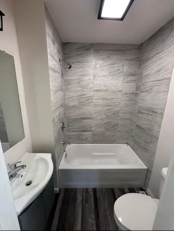 a bathroom with a sink a toilet and bathtub