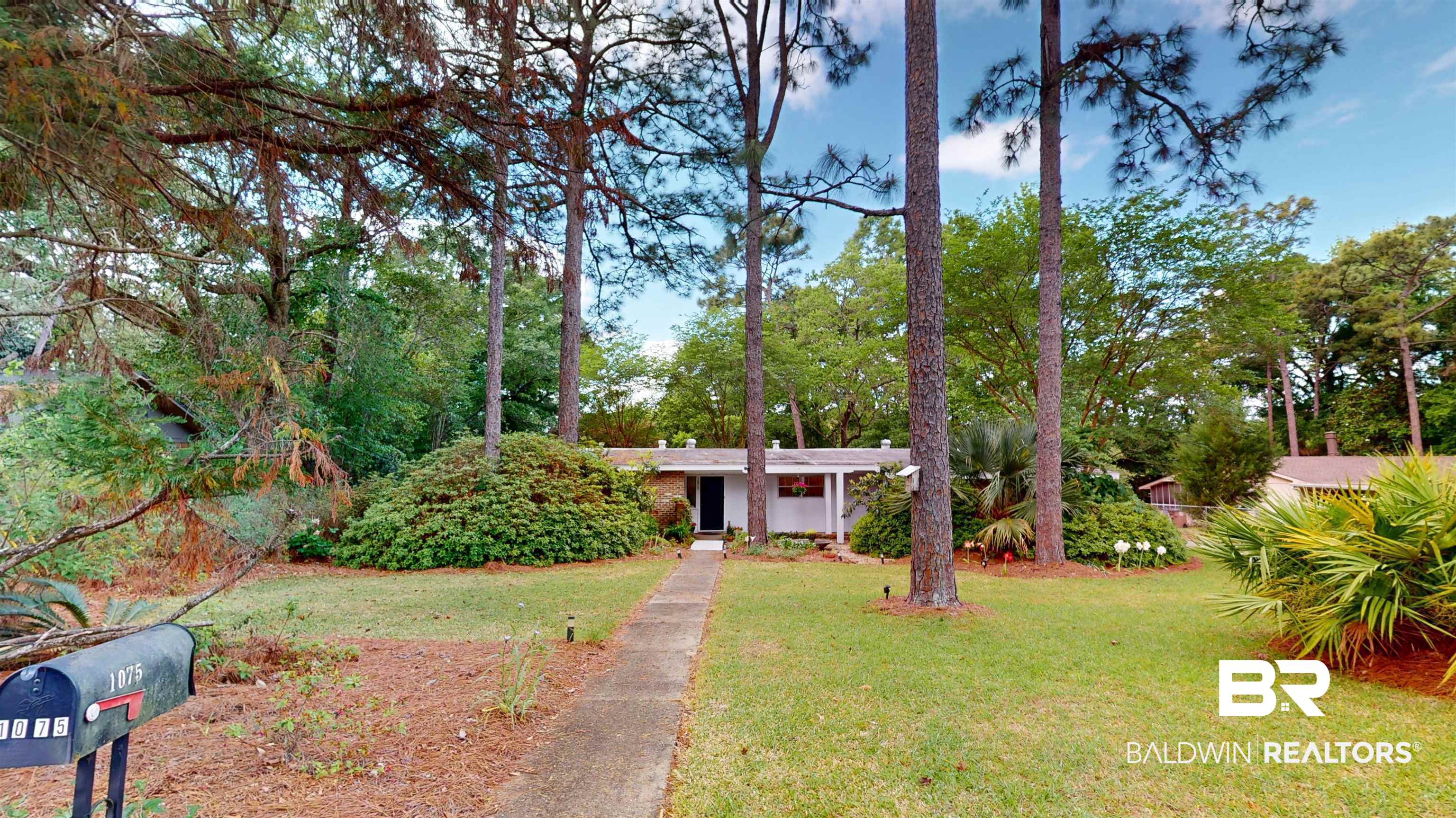 1075 Zurich Street Mobile, AL 36608 - Photo 2 of 35 View of front of house featuring a front yard and view of wooded area