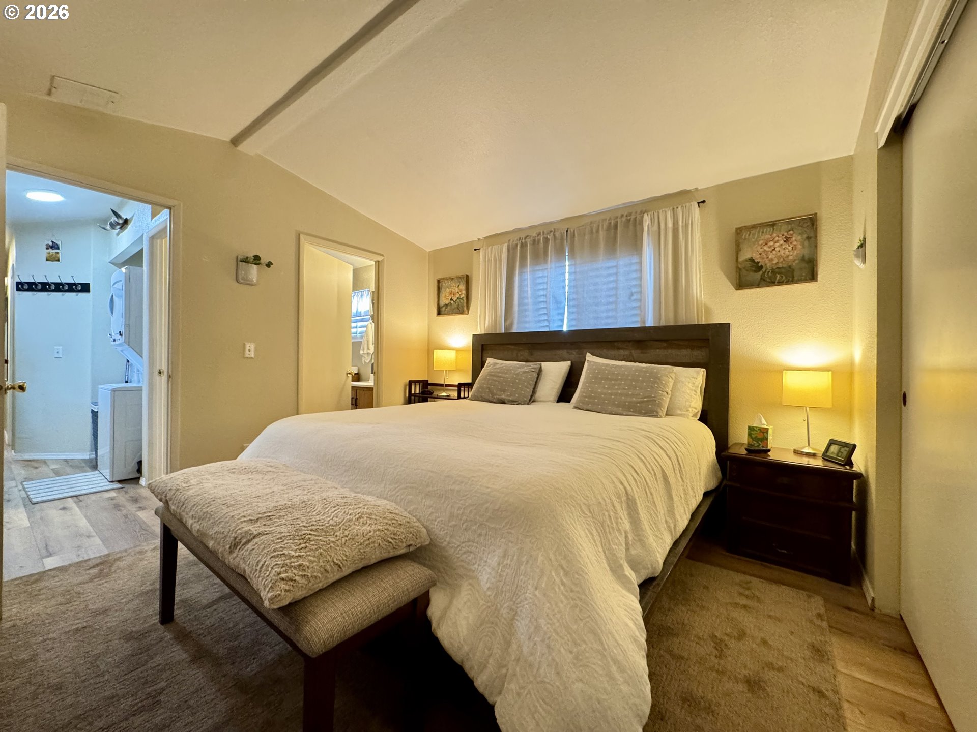 3760 Highway 101, Unit 1 Florence, OR 97439 - Photo 8 of 32 a bedroom with a bed and wooden floor