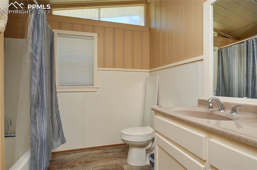 20 Main Street Silver Cliff, CO 81252 - Photo 12 of 28 a bathroom with a granite countertop sink toilet and a mirror