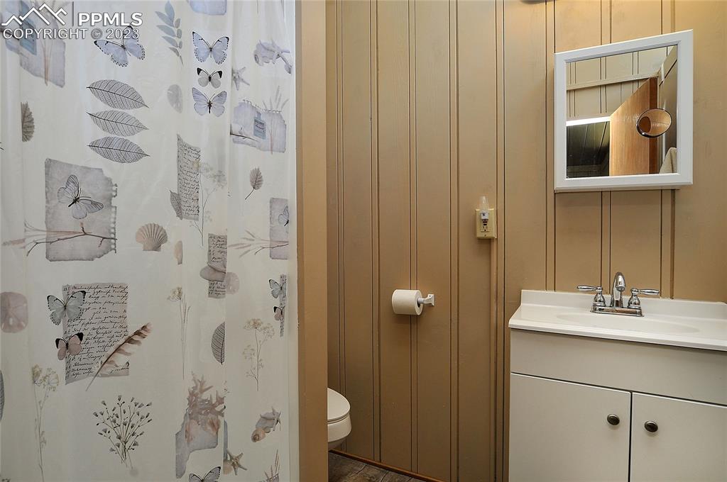 20 Main Street Silver Cliff, CO 81252 - Photo 15 of 28 a bathroom with a granite countertop sink a mirror and shower