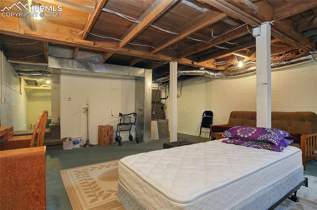 20 Main Street Silver Cliff, CO 81252 - Photo 17 of 28 a bed room with a bed and a chair