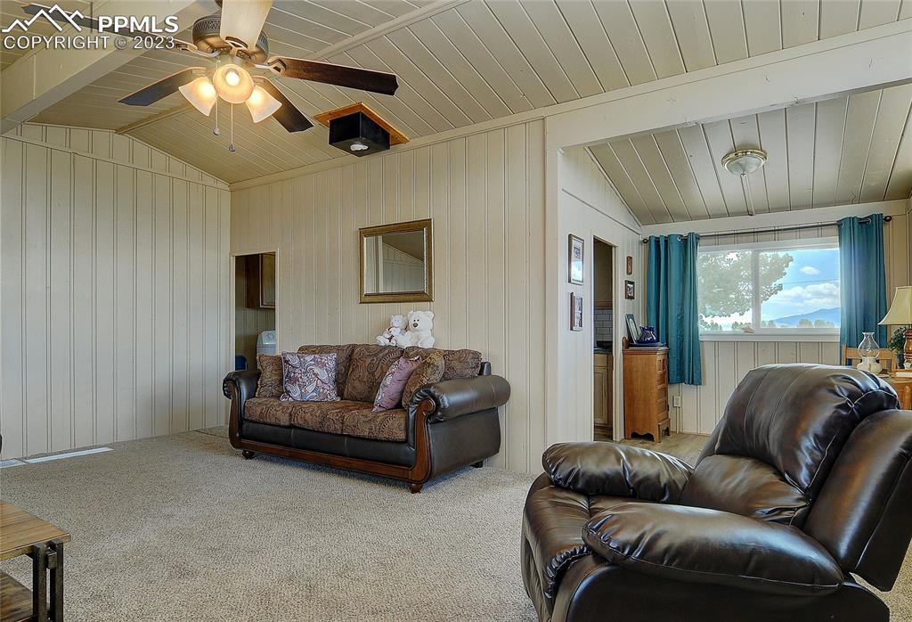 20 Main Street Silver Cliff, CO 81252 - Photo 9 of 28 a living room with furniture and a chandelier