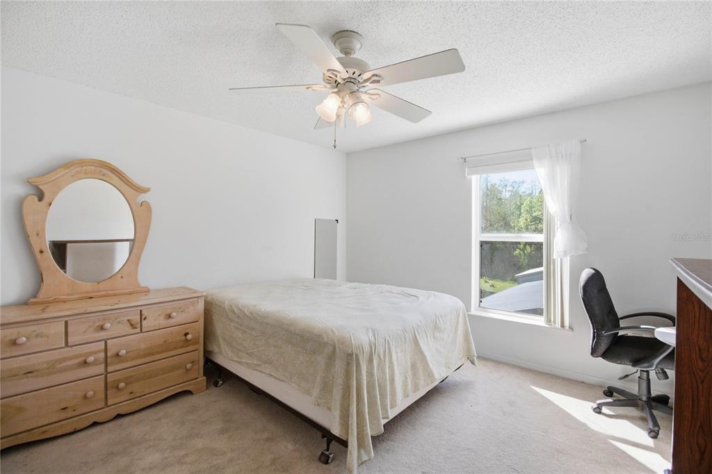 206 Taranto Way Kissimmee, FL 34758 - Photo 27 of 45 a bedroom with a bed a window and painting on the wall