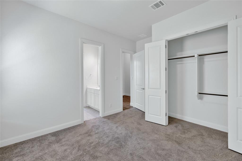 2307 Sam Street Mansfield, TX 76063 - Photo 6 of 23 Unfurnished bedroom with light colored carpet, a closet, and ensuite bath