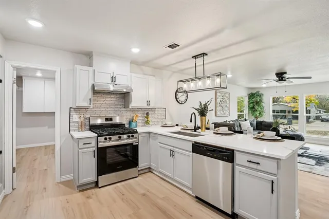 a kitchen with a sink stove and cabinets