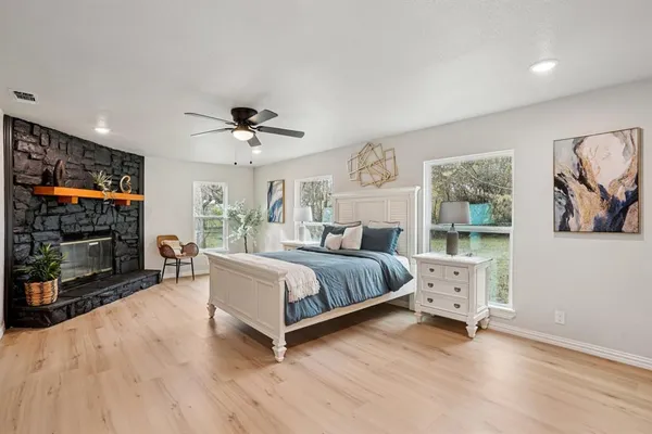 a spacious bedroom with a bed and a flat screen tv