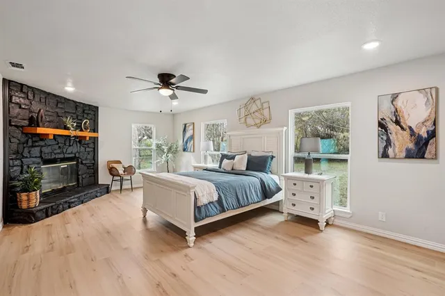 a spacious bedroom with a bed and a flat screen tv