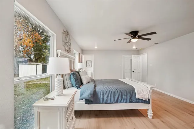 a living room with a bed furniture and a large window