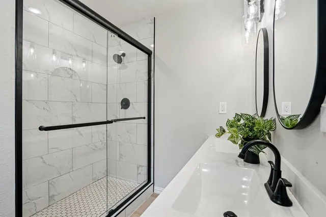 a bathroom with a shower and a sink