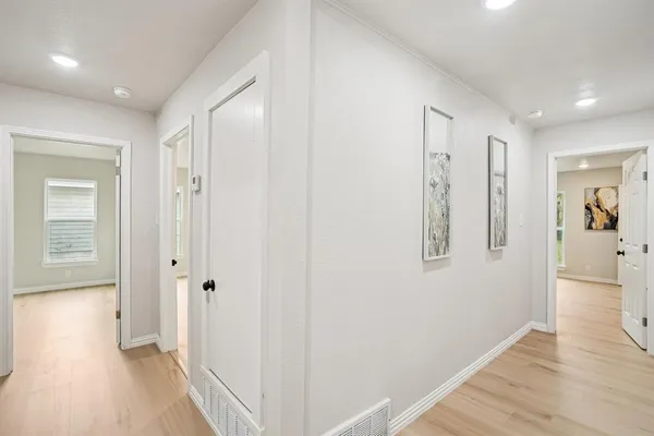 a view of a hallway with wooden floor