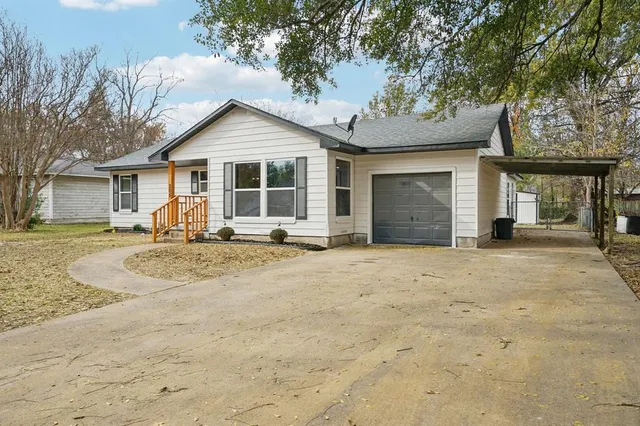 a view of a house with a yard covered in snow