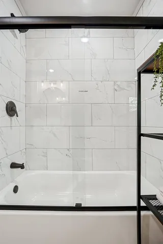 a bathroom with a bathtub and shower