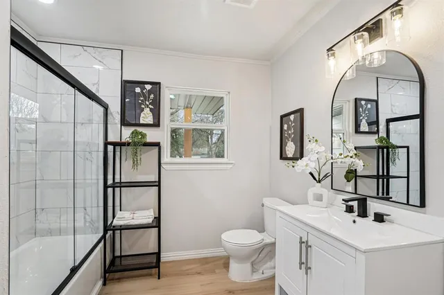 a white toilet sitting next to a bathroom sink